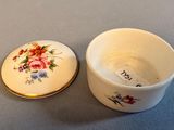a small cup with a lid that has a flower design on it