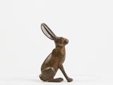 a bronze statue of a rabbit sitting on its hind legs