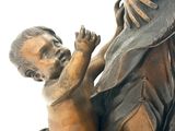 a bronze statue of a woman holding a child