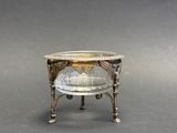 an image of a silver plate with a glass bowl on it