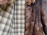 a coat with a fur collar on a mannequin mannequin mannequin mannequin mannequin mannequin mannequin mann