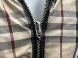 the zipper of a jacket with a checkered pattern on it