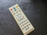 a remote control sitting on top of a black table