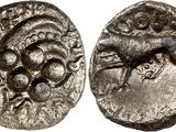 a silver coin with an image of a horse on it