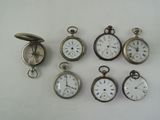 many different types of pocket watches on a white surface