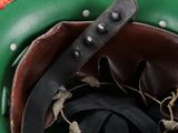 a close up of a green and red helmet with a leather band