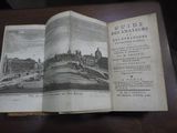 un livre ouvert posé sur une table, avec la photo d'un bâtiment