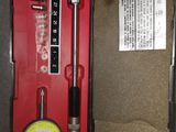 a red box with tools inside of it on the floor