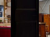 a tall black cabinet in the middle of a room