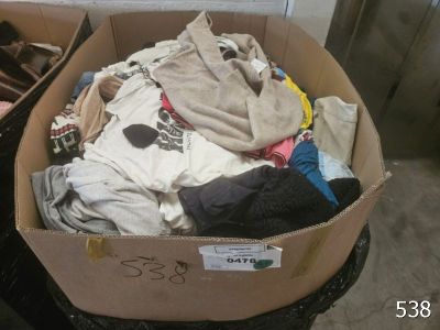a cardboard box filled with clothes and other items