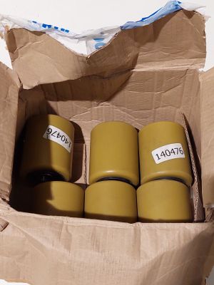 quatre rouleaux de ruban adhésif dans une boîte en carton posée sur une table