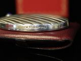 a silver ring sitting on top of a red case