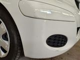 a close up of a car ' s front bumper with a hole in it