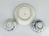 three bowls and a clock on a white table