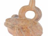 a small vase with a frog on it on a white surface