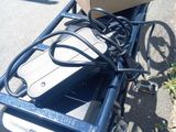 a box sitting on top of a cart on the side of the road