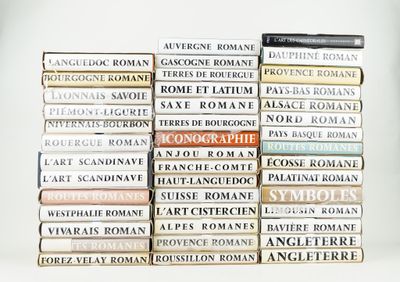 several books stacked on top of each other on a white surface
