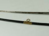 two old swords are sitting on top of a white table