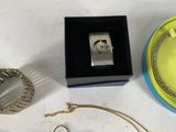 a lot of jewelry sitting on a table next to each other