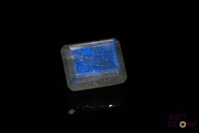 a close up of a square blue stone on a black surface