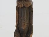 wooden figurine of a man with a hat on his head
