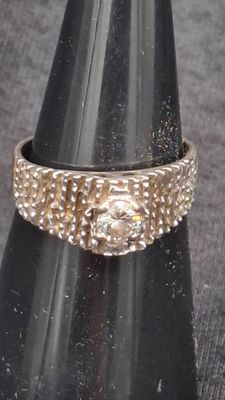 a close up of a ring on top of a cone