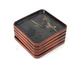 four square wooden coasters with a signature on them