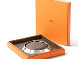 an orange box with a silver bracelet inside of it