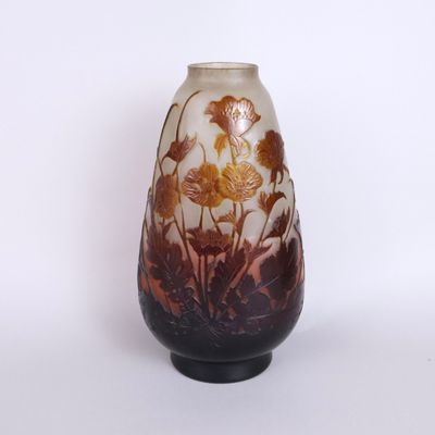 a vase with a flower design on it on a table