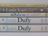 four books stacked on top of each other on a white surface
