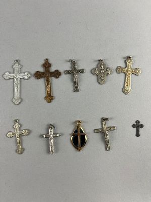 a close up of a group of crosses on a white surface