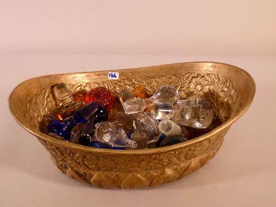 a gold bowl filled with crystal stones on a white table