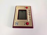 an image of a red and gold electronic device on a white surface