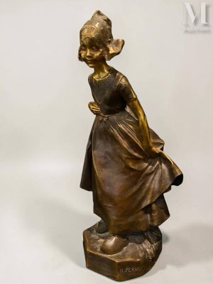 bronze statue of a girl with a basket on her head
