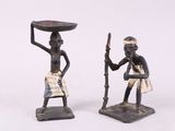 pair of african figurines of a man and a woman with a bowl on their head