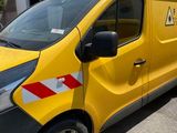 the yellow van is parked on the side of the road