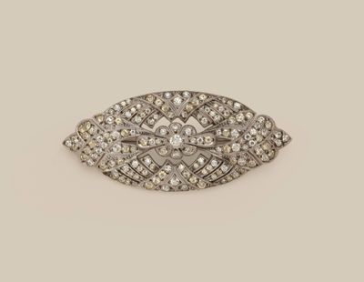 a close up of a diamond broochle on a white background