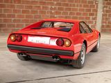 a red sports car parked in front of a brick wall