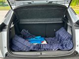 the trunk of a car with a sleeping bag in the trunk