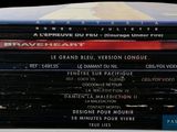 many dvds stacked on top of each other on a table