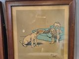 two framed pictures of dogs playing with each other on a table