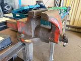 an old vise on a workbench in a workshop