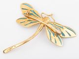 an image of a gold dragonfly brooch on a white background