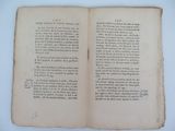 a book open on a table with a white background