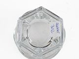 a clear glass ashtray with a blue marker on it