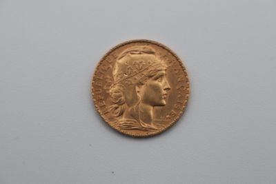 a close up of a gold coin with a woman ' s face on it