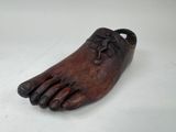 un vieux sabot en bois orné d'une fleur sur la pointe