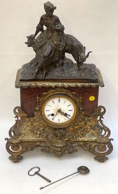 a clock with a statue of a woman and a dog on it