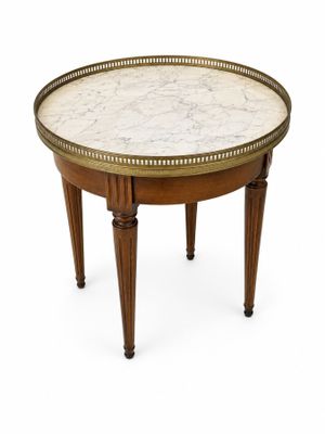 une photo d'une table au plateau en marbre et aux pieds en bois