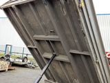 a dumpster that is sitting in the back of a truck